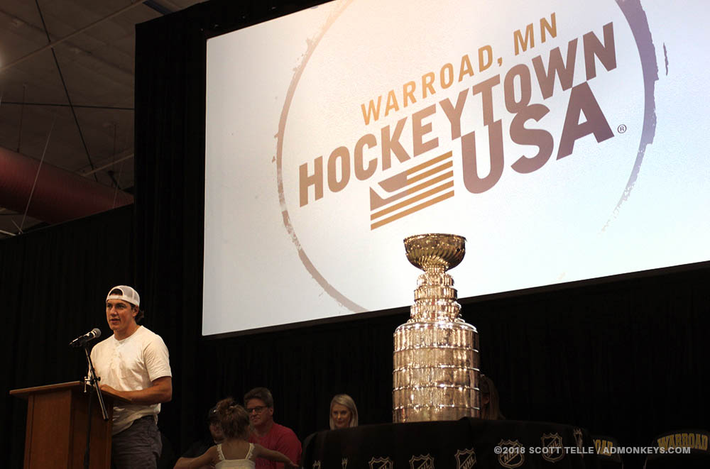 TJ Oshie carries the Stanley Cup inside a bar.