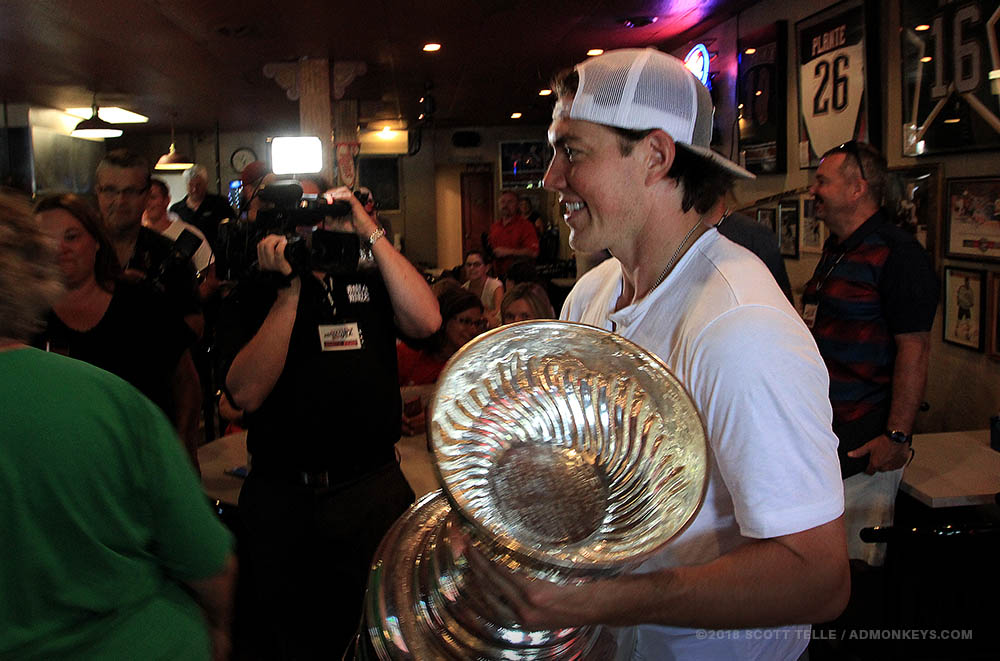 TJ Oshie carries the Stanley Cup inside a bar.