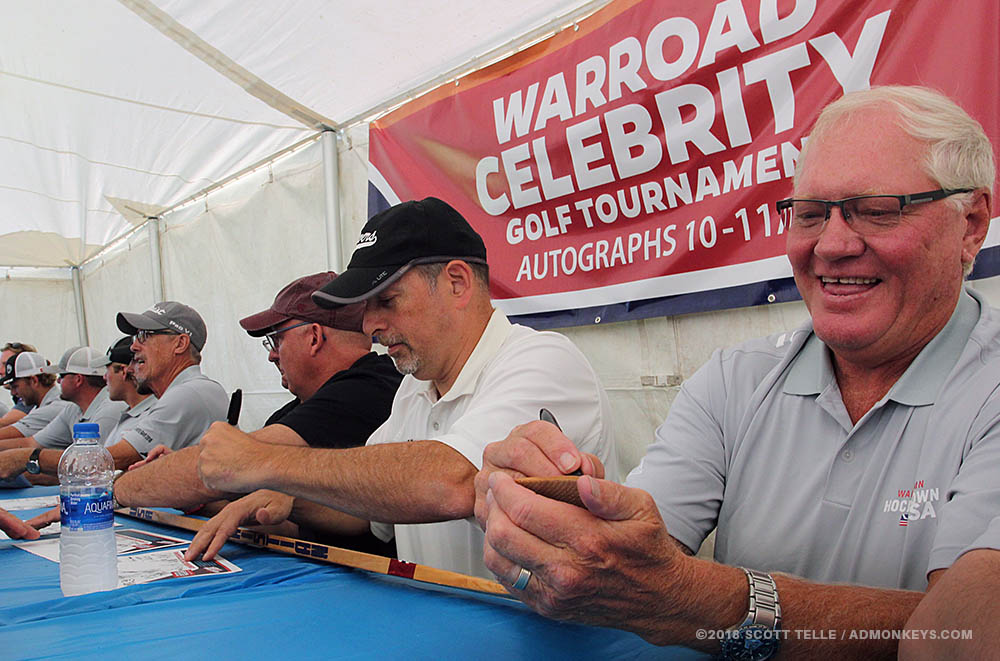 An artist holds up her traditional paper cuts for the camera.