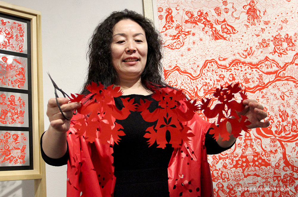 admonkeys_Chinese_PaperCut_Artist_WEB+Tag_2 An artist holds out her traditional paper cut art for the camera.